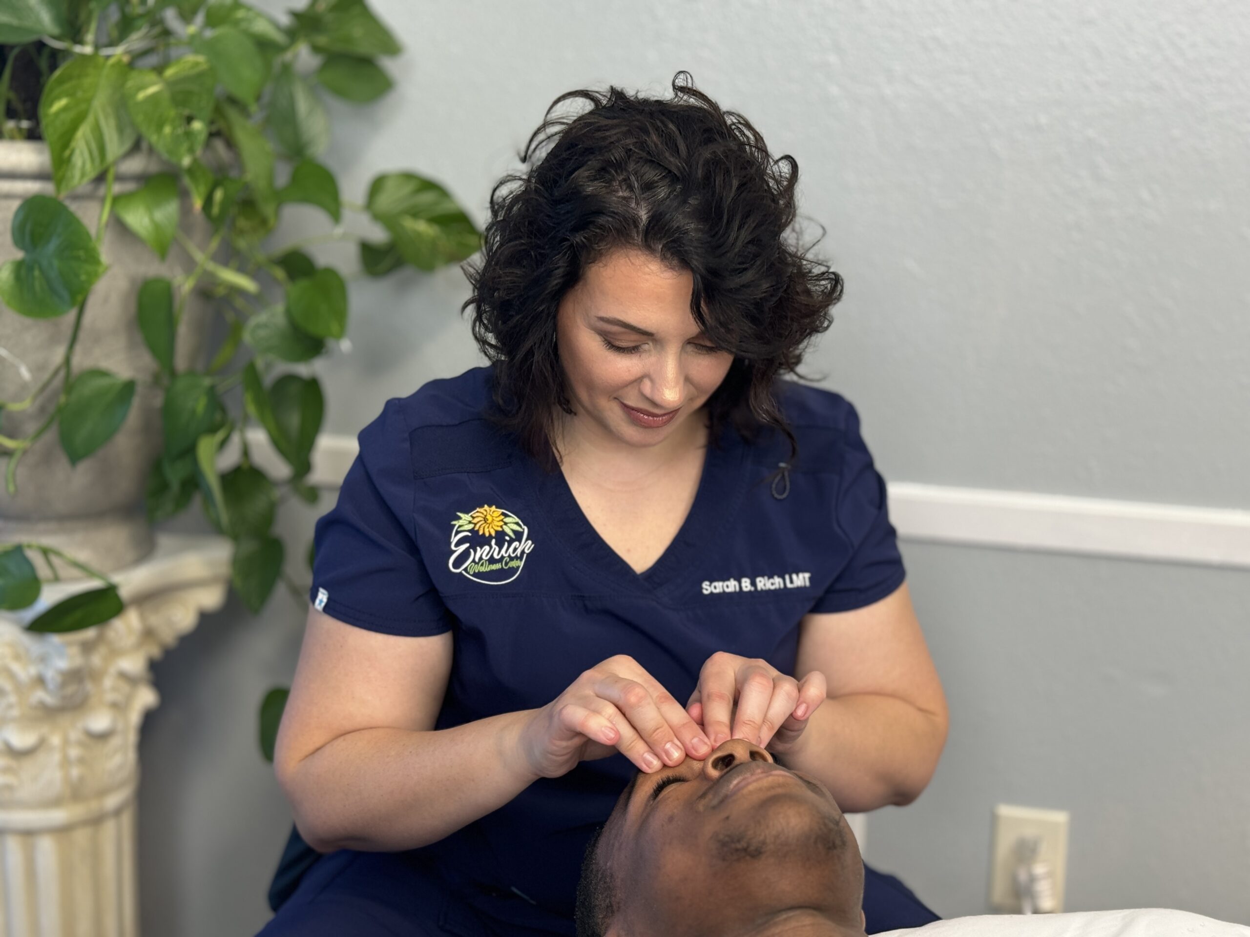 Licensed massage therapist Sarah B Rich performs facial massage